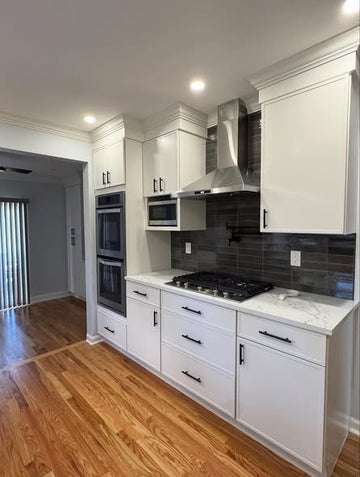 All-White Kitchen Cabinetry with Integrated Double Ovens &amp; Gas Cooktop