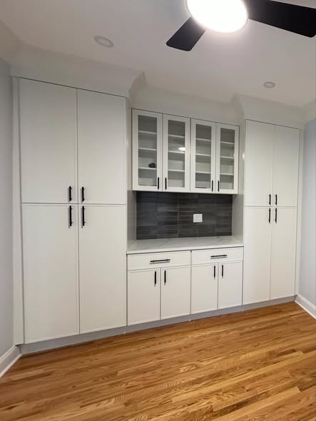 All-White Kitchen Cabinetry with Integrated Double Ovens &amp; Gas Cooktop 
