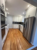 All-White Kitchen Cabinetry with Integrated Double Ovens & Gas Cooktop