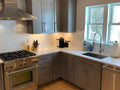 Contemporary Charcoal Gray Kitchen Cabinetry with White Quartz