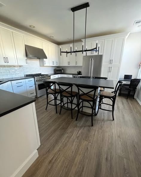 Contemporary Cream Kitchen Cabinetry with Black Island & amp.