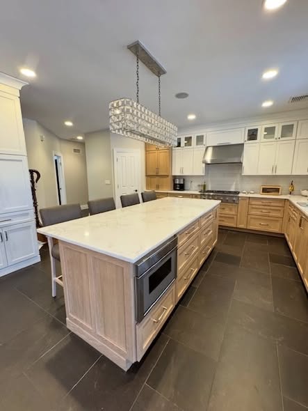 Mixed-Tone Kitchen Cabinetry with Built-In Appliances &amp; Marble Counters