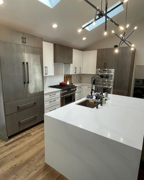Modern Three-Tone Kitchen Cabinetry with Casual Bar Island