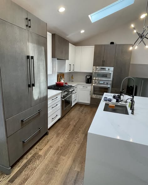 Modern Three-Tone Kitchen Cabinetry with Casual Bar Island