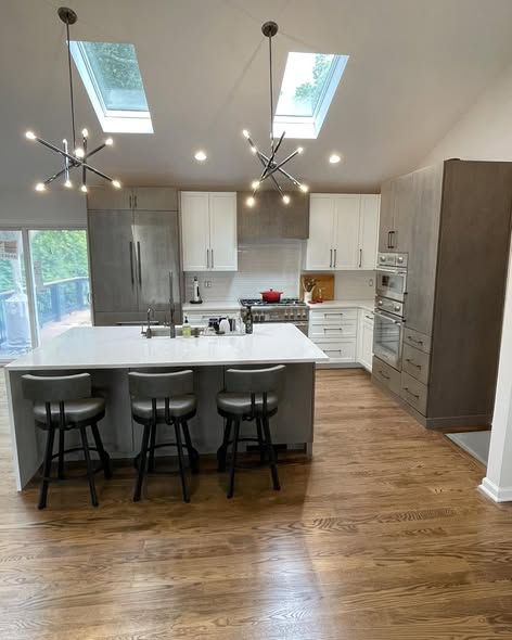 Modern Three-Tone Kitchen Cabinetry with Casual Bar Island