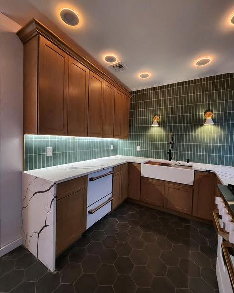 Warm Wood Kitchen Cabinetry with Green Backsplash &amp; Quartz Counters