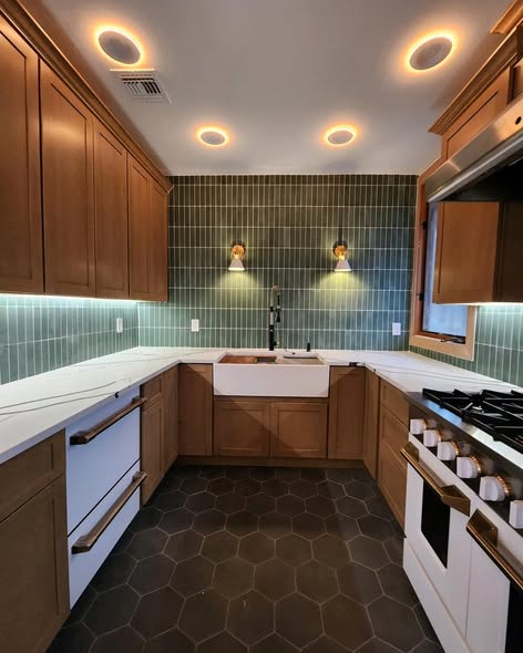 Warm Wood Kitchen Cabinetry with Green Backsplash &amp; Quartz Counters